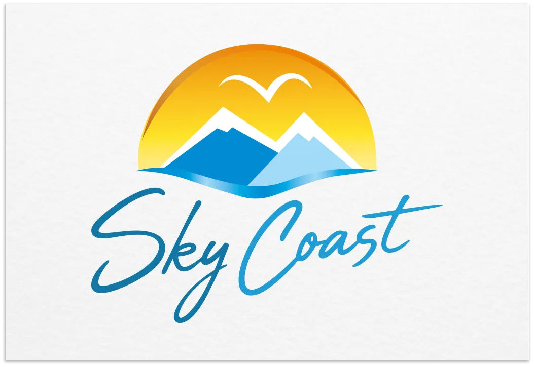 Sky Coast travel logo with mountains, blue waves, a bird and a golden sunset